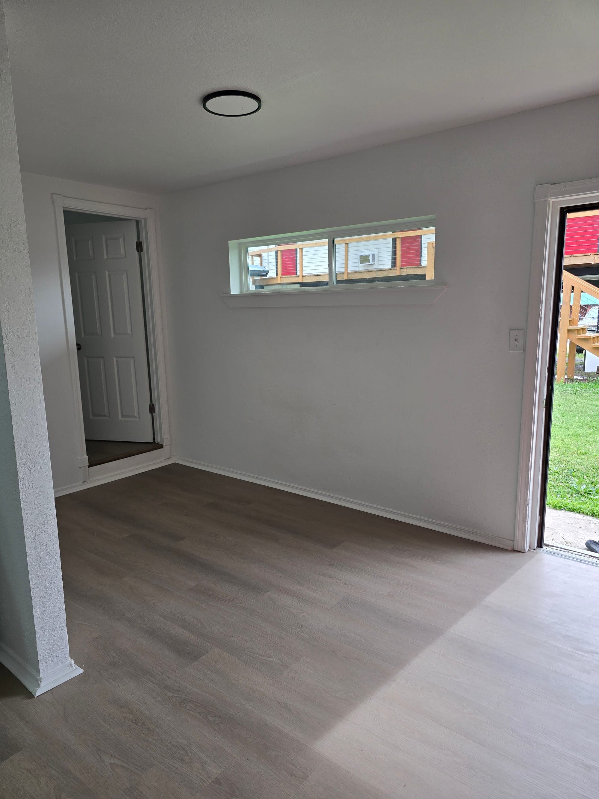 One bedroom apartment living area with updated flooring and natural light